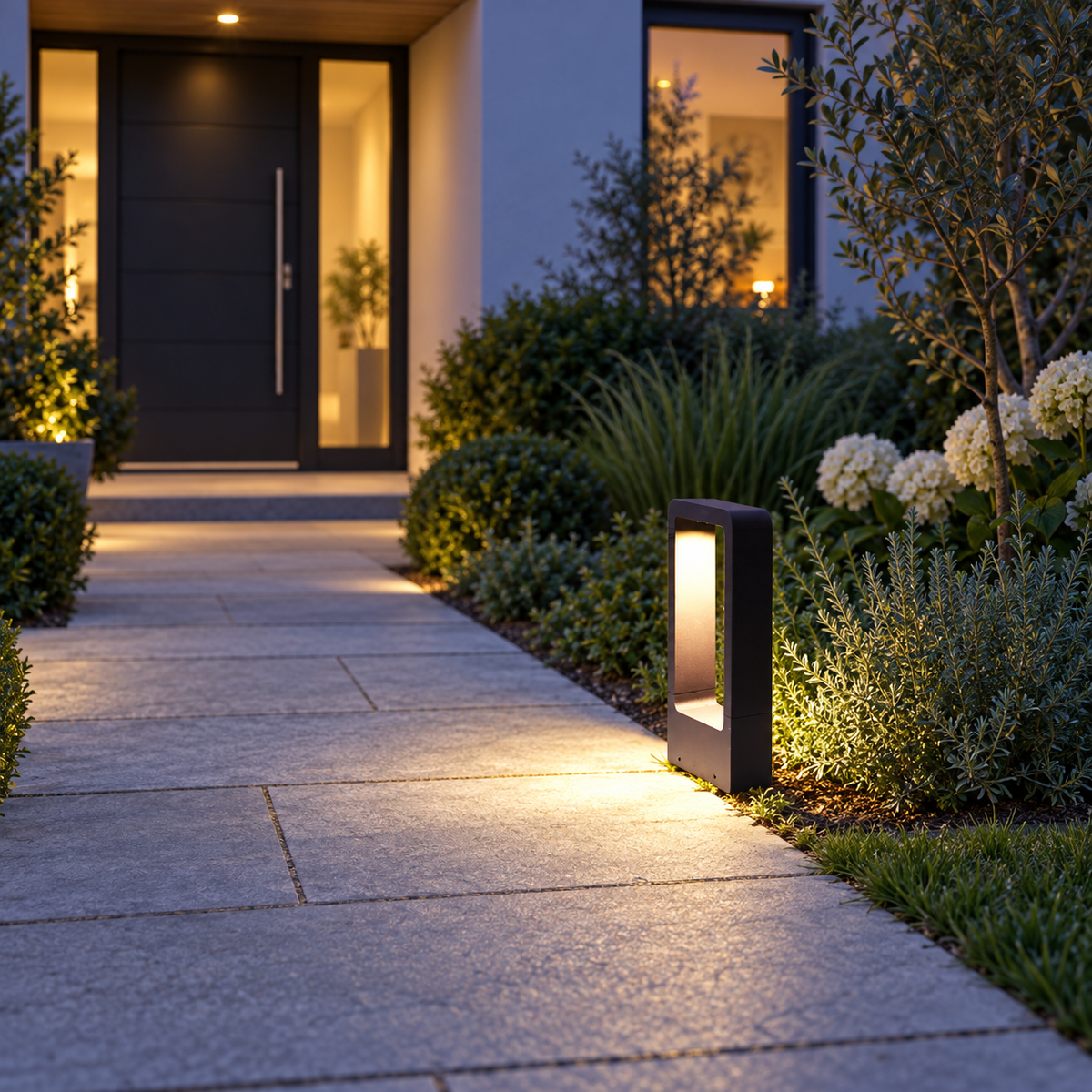 Black LED garden bollard light illuminating a path – editorial lifestyle image one